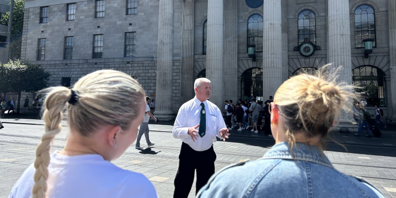 man standing in front of building with pillars
