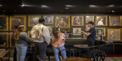abbeytheatretour-allenkiely-7676 Guests looking at pictures in gold frames on wall